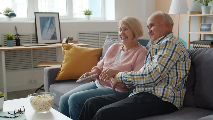 An older couple laughing together at home